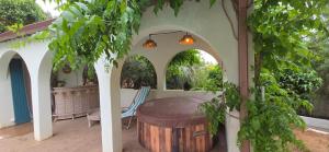 an outdoor patio with a table and a barrel at Casa Esperanto in Béziers