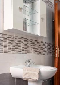 a bathroom with a sink and a mirror at Appartamenti ABR Porto in Le Castella +28 photos