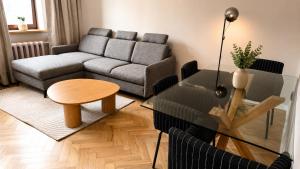 a living room with a couch and a table at Greystone Suites & Apartments in Riga