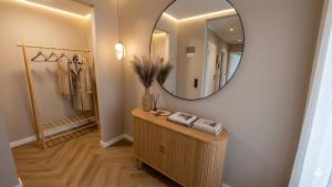 a dressing room with a mirror on the wall at Greystone Suites & Apartments in Riga +58 photos