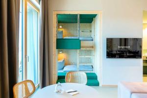 a small room with a table and chairs and a bed at Hotel & Restaurant Heyligenstaedt in Gießen