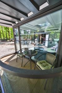 a screened in porch with a table and chairs at Rado Hotel Spa in Khmilnyk