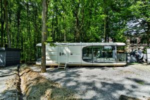 a white trailer is parked in front of some trees at Rado Hotel Spa in Khmilnyk