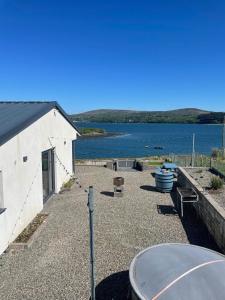 a building with a view of a body of water at Tigh an Trá in Bantry +14 photos