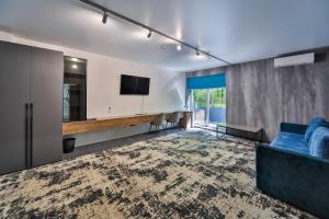 a living room with a blue couch and a tv at Rado Hotel Spa in Khmilnyk
