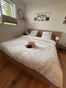a bedroom with a large bed with a hat on it at Chez Baron in Hauterive
