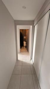 a hallway with a toilet in a white room at Appartement 2 Pièces in Annemasse