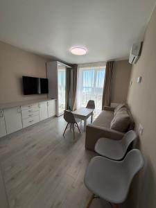 a living room with a couch and a table at Студия с Видом на Море, 9-2 in Chornomorsk
