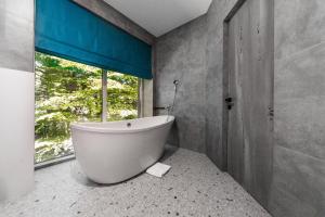 a bath tub in a bathroom with a window at Rado Hotel Spa in Khmilnyk +97 photos