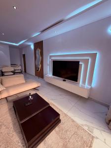 a living room with a large flat screen tv at Appartement spacieux et confortable in Abidjan