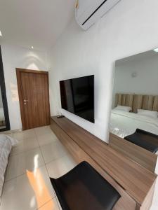 a living room with a flat screen tv on a wall at Appartement spacieux et confortable in Abidjan