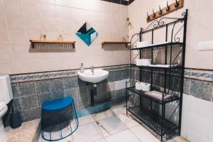 a bathroom with a sink and a blue stool at Casa Caracol in Cádiz +126 photos