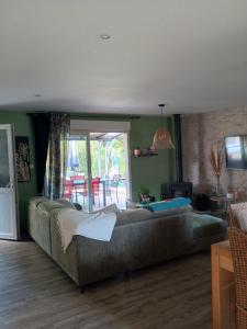 a living room with a couch and a television at Gite du gachou in Souillac +36 photos