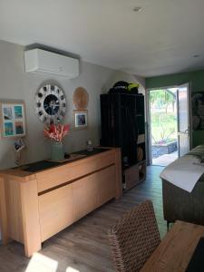 a living room with a entertainment center and a tv at Gite du gachou in Souillac