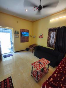 a living room with a couch and a table at AKS Cottage in Yercaud