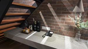 a kitchen counter with a brick wall at Atelier Hotel Permas in Johor Bahru +154 photos