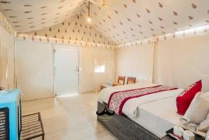 a bedroom with a large bed in a room at Hostel Desert Camp Sam in Jaisalmer