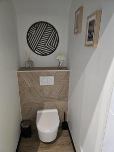 a bathroom with a toilet and a wooden dresser at Sarments et Bulles in Ambonnay +31 photos