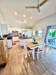 a kitchen and dining room with a table and chairs at Cocoplum #8 Condo in George Town +42 photos