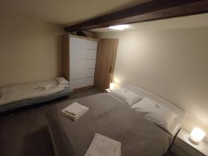 a bedroom with two beds and a door with two lights at Apartma Silvester in Bovec