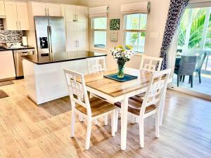 a kitchen and dining room with a table and chairs at Cocoplum #8 Condo in George Town