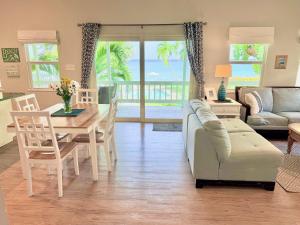 a living room with a couch and a table at Cocoplum #8 Condo in George Town