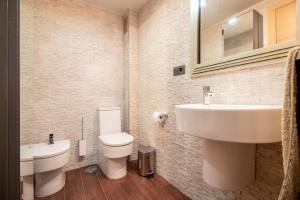 a bathroom with a white sink and a toilet at Plaza España - Nerja centro in Nerja +16 photos