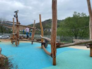 a childrens playground with a wooden swing set at Haus Anna in Zell an der Mosel