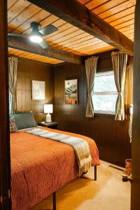 a bedroom with a bed in a room with a ceiling at Creekside Chalet - Huge Indoor Spa in Bessemer