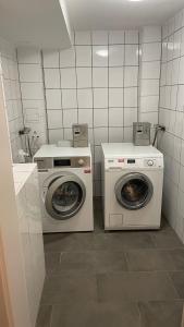 a laundry room with a washer and a washing machine at CASA VIVA Panorama Suites in Villach