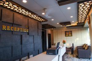 an office with a reception desk and a sign that reads reception at Hotel Strawberry Grand in Rāmeswaram