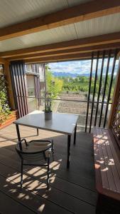 a table and a chair on a porch with a view at CASA VIVA Panorama Suites in Villach