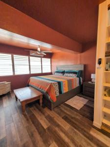 a bedroom with a bed and a table in it at Charming 3-Bedroom House Steps from Luquillo Beach in Luquillo