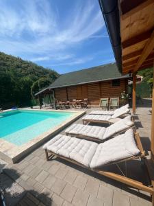 a row of mattresses sitting next to a swimming pool at PARADISO pool&house in Prosek