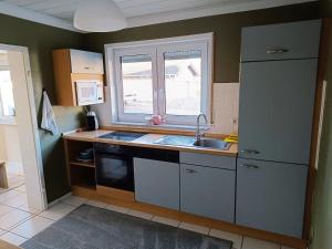 a small kitchen with a sink and a window at Gemütliches Apartment im Naturpark Rhein-Westerwald in Raubach