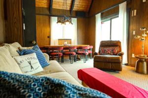 a living room with a couch and a table at Creekside Chalet - Huge Indoor Spa in Bessemer