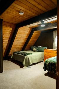 a bedroom with a bed and a wooden ceiling at Creekside Chalet - Huge Indoor Spa in Bessemer +39 photos