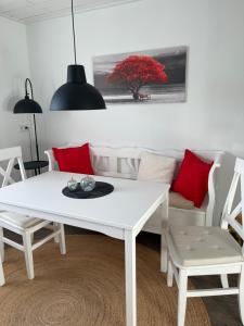 a white table and chairs in a living room at Auszeit in Melsungen +13 photos