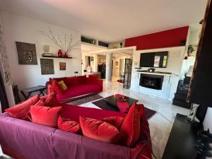 a living room with a red couch and a fireplace at PENTHOUSE LUXE - Rome in Rome