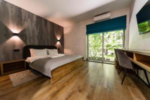 a bedroom with a bed and a large window at Rado Hotel Spa in Khmilnyk