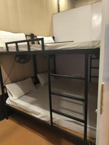 a bunk bed with a laptop on top of it at AC Dormitory in Varanasi