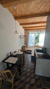 a kitchen and dining room with a table and a counter at Fachwerk Studio in Leipzig
