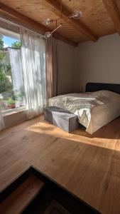 a bedroom with a bed and a large window at Fachwerk Studio in Leipzig +18 photos