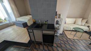 a kitchen with a sink and a bed in a room at Fachwerk Studio in Leipzig