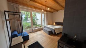 a living room with a bed and a window at Fachwerk Studio in Leipzig