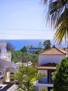a view of a house with the ocean in the background at Amfitrion Apartments in Gythio
