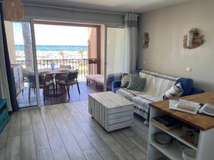 a living room with a couch and a table at Blue Lagoon in Six-Fours-les-Plages