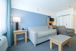 a living room with a couch and a table at Two Trees Inn in Ledyard Center