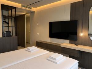 a living room with a flat screen tv on a wall at Wabi Hotel - Beauty & Dental Center in Sopron
