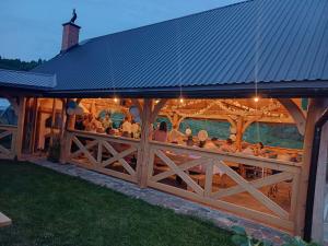 a group of people sitting at a restaurant in a building at Agroturystyka Na Jamie in Posada Jaśliska